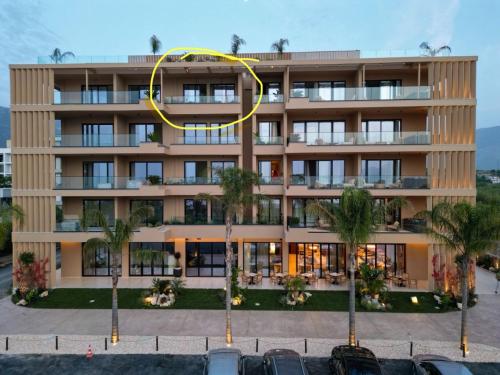 a large building with a yellow circle on it at Radhime Luxury Apartments sleeps 5 in Orikum