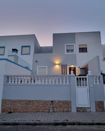 a white house with a gate and a fence at Casa Yucca in Salema