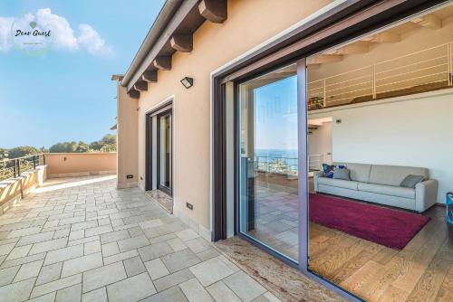 a living room with sliding glass doors and a couch at Anima Mediterranea in Albenga