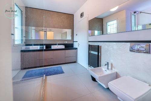 a large bathroom with a sink and a toilet at Anima Mediterranea in Albenga