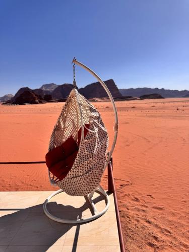 a chair sitting in the middle of the desert at Rum Angel Camp in Wadi Rum