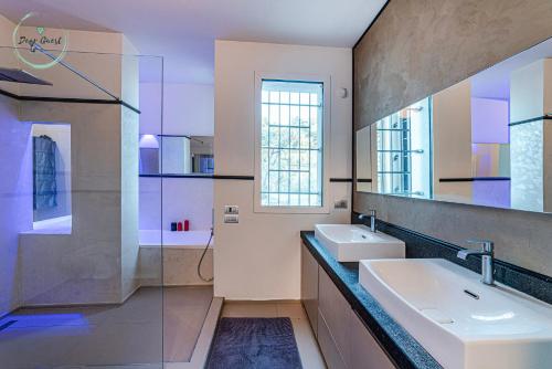 a bathroom with two sinks and a mirror at Anima Mediterranea in Albenga