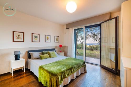 a bedroom with a bed and a large window at Anima Mediterranea in Albenga