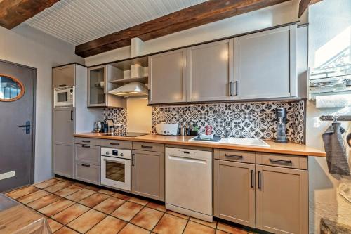 Il comprend une cuisine avec des appareils en acier inoxydable et du parquet. dans l'établissement Authentique maison de caractère à Ploumoguer, à Ploumoguer