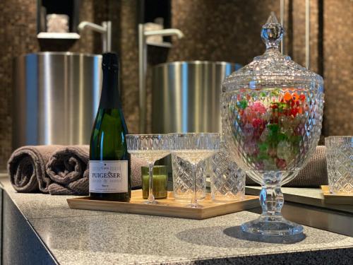 a bottle of wine and a glass on a counter at Off Tower Hotel in Halle