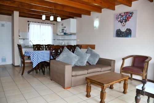 a living room with a couch and a table at Cabañas Rey Pacific in La Serena
