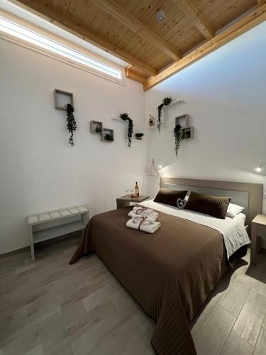 a bedroom with a large bed with two towels on it at Radici Mare B&B in Torre dell'Orso