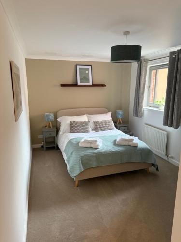 a bedroom with a bed with two towels on it at Marine parade apartment with river view in Dundee