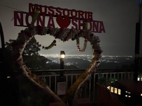 a sign that readsmission nova usa at night at Nona shona chill point homestay and cafe in Mussoorie