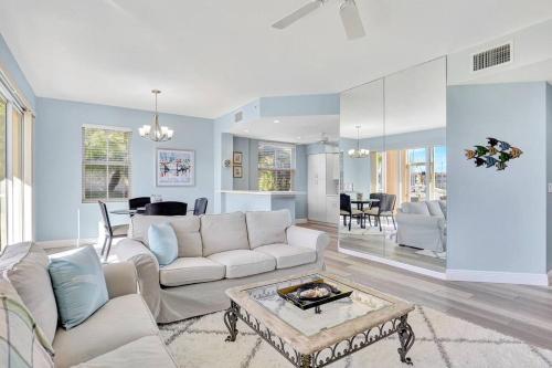 a living room with a white couch and a table at Dockside Delight Waterfront Oasis in Punta Gorda