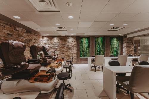 a hair salon with chairs and tables and windows at Pillar and Post Inn & Spa in Niagara on the Lake