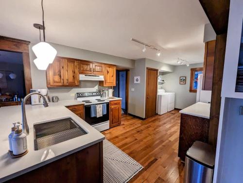 a kitchen with a sink and a stove top oven at Lone Pine Oceanfront Cottage in Prospect Harbor