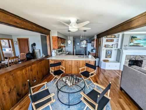 a kitchen and living room with a table and chairs at Lone Pine Oceanfront Cottage in Prospect Harbor