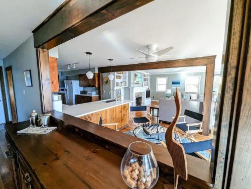 a kitchen and living room with a large mirror at Lone Pine Oceanfront Cottage in Prospect Harbor