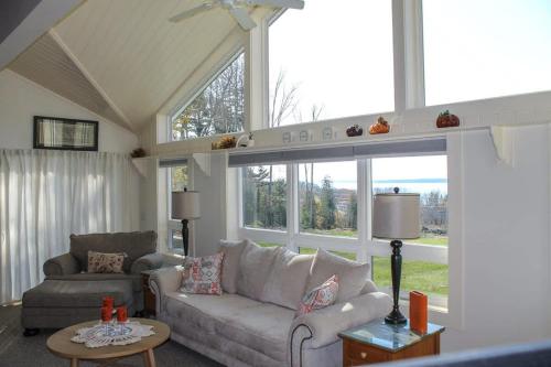 a living room with a couch and a chair at Bayside Waterview Cottage in Ellsworth