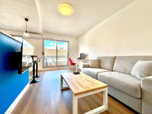 un salon avec un canapé et une table dans l'établissement Le Moderne à Nîmes, proche Arènes et gare, à Nîmes