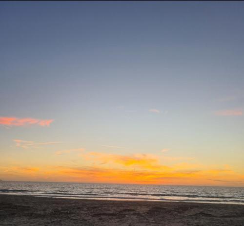 a sunset on a beach with the ocean at Albanian Dream Escape Apartment in Golem