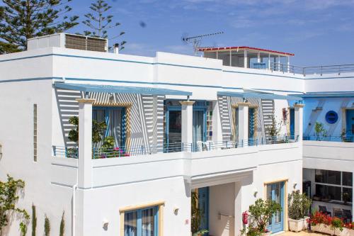 a white building with balconies on it at Blue Calm in Daratso
