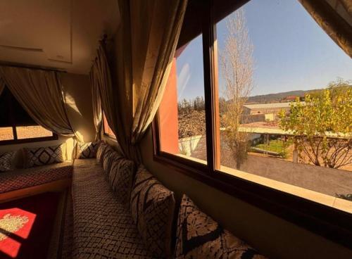 a room with a large window with a view at Espace vert Chalet familial à Azrou in Azrou