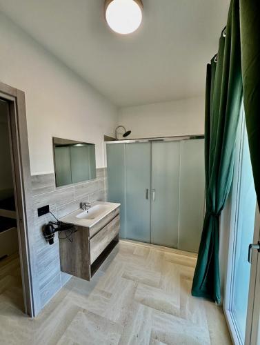 a bathroom with a sink and a mirror at Green Home in Bari