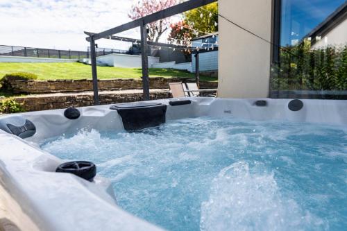 a jacuzzi tub with water in a backyard at Stalybridge Sanctuary - Luxe Hot Tub Retreat in Stalybridge