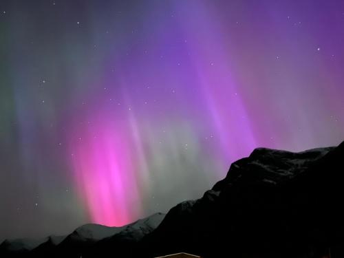 an image of the northern lights in the sky at Flo Lake House in Stryn