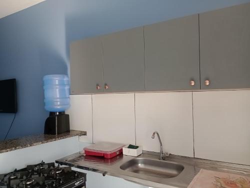 a kitchen with a sink and a counter top at Refúgio no Centro in Imperatriz