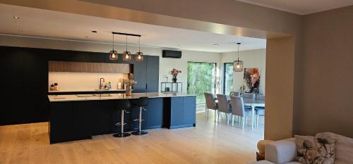 a kitchen and living room with a dining room at Beautifull house with 7 bedrooms in Sandefjord