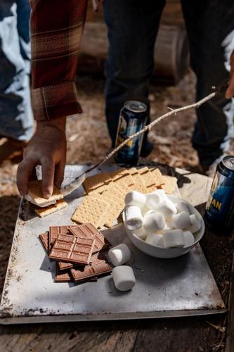 a person is cutting food on a table at Blue Basecamp - Adventure Starts Here! in Shaver Lake
