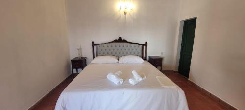 a bedroom with a bed with two white shoes on it at LUCIO l in Cachí