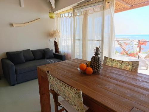 a living room with a wooden table with a pineapple on it at Boadream Ca' Madeira 1 Attico Linea Prestige in Sal Rei