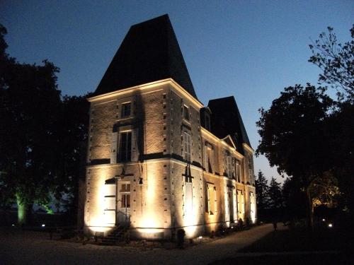 a large building with lights on it at night at Château de Bellevue - Appartement in Sainte-Cécile