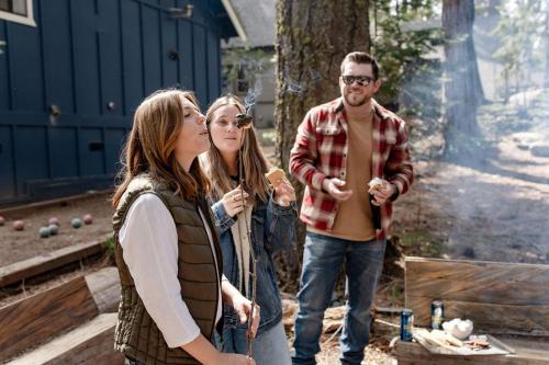 a group of people standing in front of a fire at Blue Basecamp - Adventure Starts Here! in Shaver Lake
