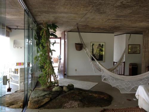 a house with a hammock in the middle of a room at Casa Angra dos Reis in Angra dos Reis