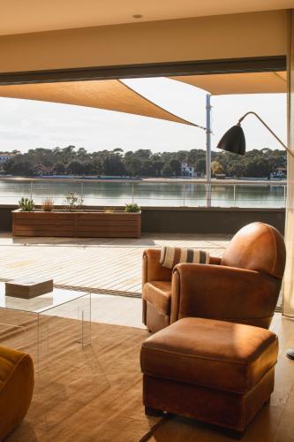 a living room with two chairs and a table at Hôtel & Spa Villa Seren in Hossegor