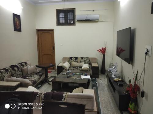 a living room with couches and a coffee table at Affordable and adorable Home in Ghaziabad