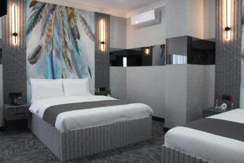 a hotel room with two beds with white sheets at City Night Hotels Ümraniye in Umraniye
