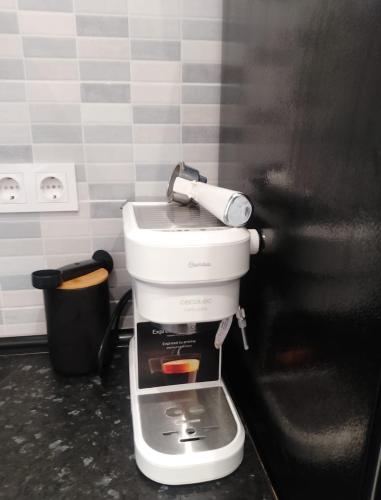 a kitchen with a coffee maker on top of it at Beach Apartment in Puerto de Mazarrón