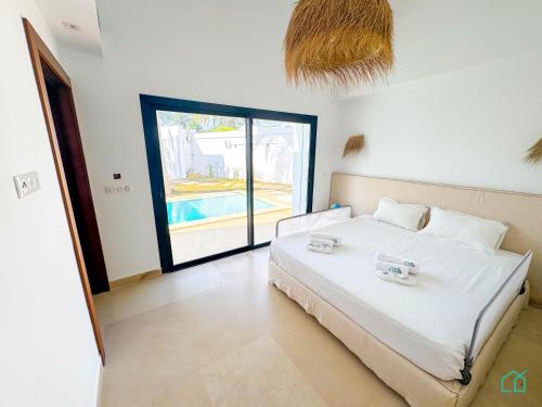 Ένα ή περισσότερα κρεβάτια σε δωμάτιο στο The Perfect Beach house in Hammamet