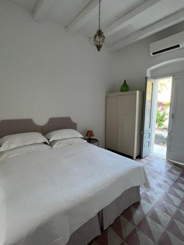 a bedroom with a large white bed in a room at La Limonaia in Veglie