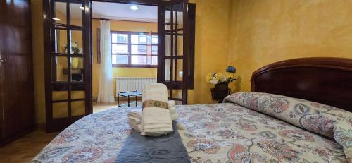 a bedroom with a bed with towels on it at Casa Pilar, Ribadesella in Ribadesella
