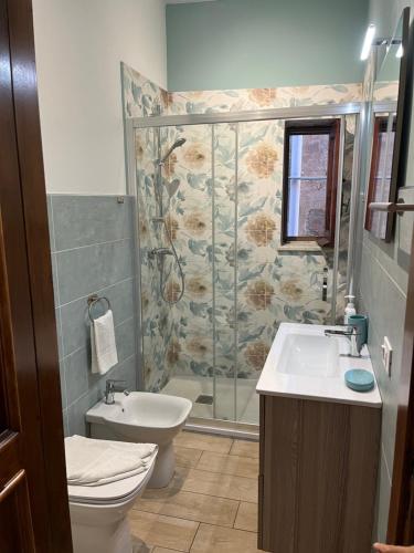 a bathroom with a shower and a toilet and a sink at Spinuzza relax in Cefalù
