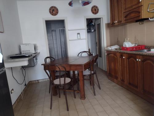 a small kitchen with a wooden table and chairs at La Casalina dell'Elba in Marciana