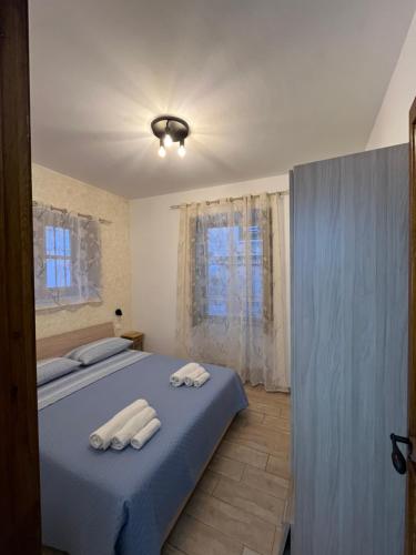 a bedroom with a bed with two towels on it at Spinuzza relax in Cefalù