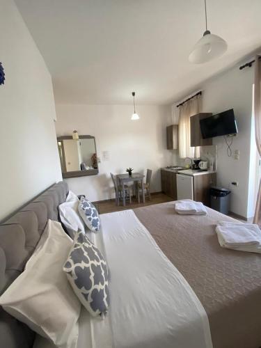 a bedroom with a large bed with pillows on it at Tile Apartments #5 in Agia Marina Nea Kydonias