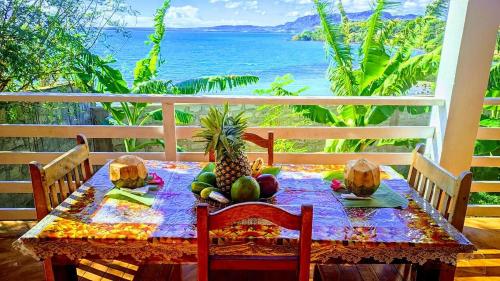 a table with fruit on it with a view of the ocean at Maison en bord de mer in Diego Suarez