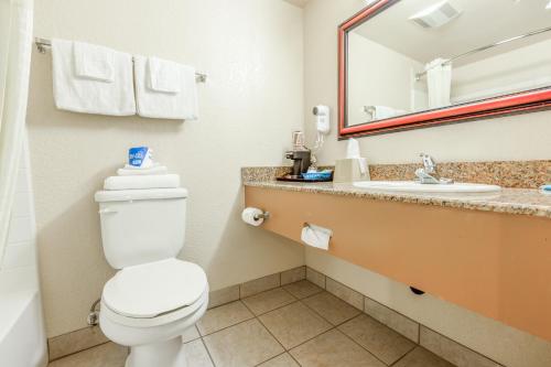 a bathroom with a toilet and a sink at Hotel Avenida, San Clemente Beach in San Clemente
