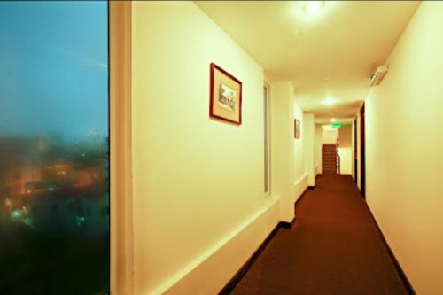 a hallway with a view of a room with a window at Việt Nam Hotel in Hue