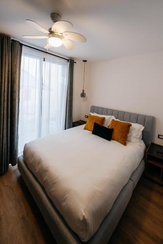 a bedroom with a large white bed and a window at Casa Castillo Condesa in Mexico City