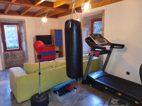 a living room with a couch and a gym at Confort, espacio y naturaleza in Jove